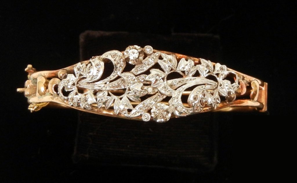 Gold bangle bracelet: Handmade 14k gold hinged bangle bracelet, front of bracelet topped with white gold and set with small paste stones, 2 1/4" inside diameter, 5/8" wide at center, foreign hallmark (unidentified) weight