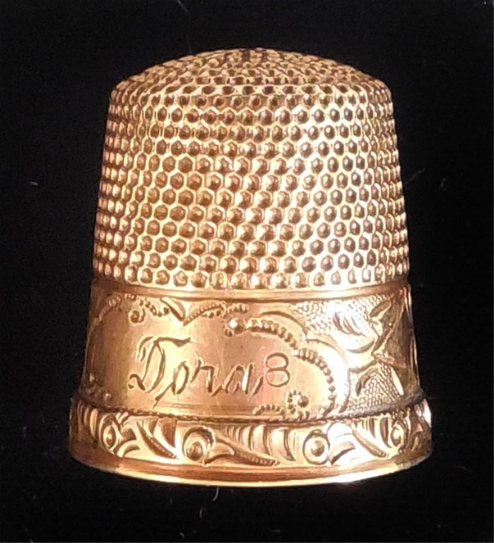 Gold thimble: 10k gold thimble, 5/8" high, engraved border and name "Dora", marked 8, unmarked for gold content, tests 10k, weight 2.4 grams/1.6 dwt, early 20th C.