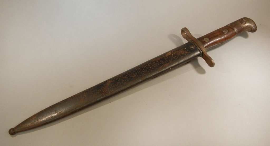 Waffenfabrik Neuhausen bayonet with scabbard: Waffenfabrik Neuhausen bayonet with scabbard, double edged bayonet, maker's mark on blade, crossguard numbered 297143, blade measures 11 5/8" long, bayonet in scabbard measures 17 1/2" long