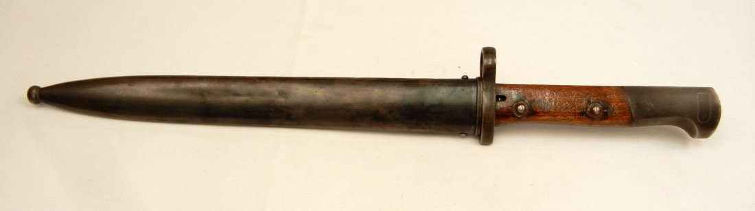 Chilean M1912 bayonet in scabbard: Chilean M1912 bayonet in scabbard, Chilean mark on ricasso, impressed OE over WG on back of ricasso, crossguard impressed C. 8837, frog hook impressed C. 1902, blade 10" long, overall 16" long