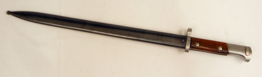 Persian Mauser bayonet in scabbard: Persian Mauser bayonet in scabbard, pommel has maker's mark, blade 15 3/4" long, overall 21 1/2" long