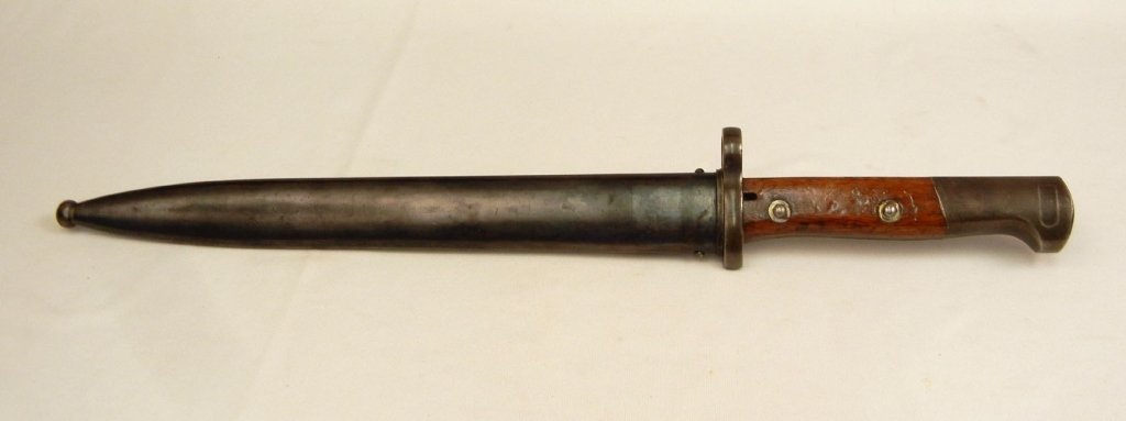 Chilean M1912 bayonet in scabbard: Chilean M1912 bayonet in scabbard, Chilean mark on ricasso, impressed OE over WG on back of ricasso, crossguard impressed A. 5840, frog hook impressed B. 7882, blade 10" long, overall 16" long