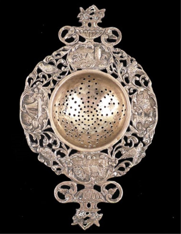 German 800 silver tea strainer: German 800 silver tea strainer, ornate decoration landscapes and birds, floral bouquet shaped handles, hallmarked, 5 3/8" across, 1.810 troy ounces