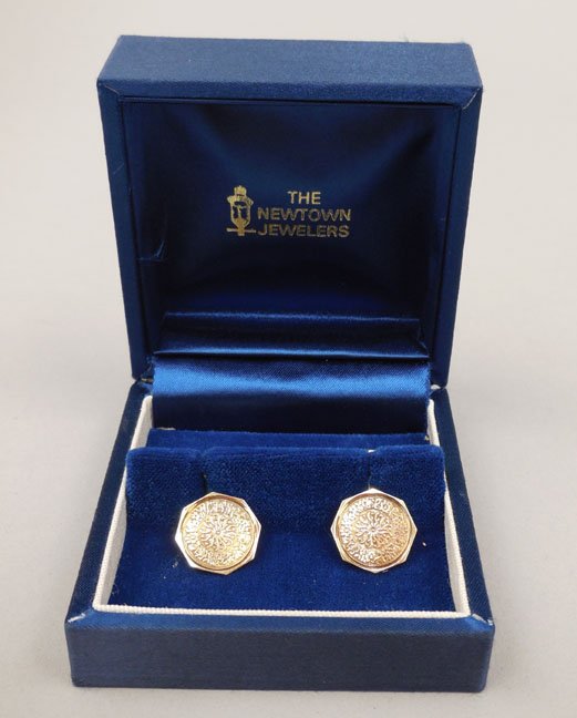 Gold cufflinks: 14k gold cufflinks in velvet box from The Newtown Jewelers, eight sided design with starburst and floral motif, 1/2" diameter, stamped 14k, weight 6.0 grams/4.0 dwt, early 20th C.