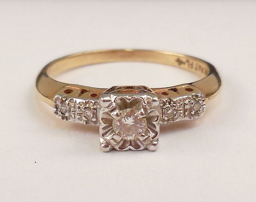 Gold and diamond ring: 14k gold diamond solitaire ring, 0.10 carat center stone with two diamond accents on either side, size 4 1/2, stamped 14k, weight 1.7 grams/1.1 dwt, ca. 1930