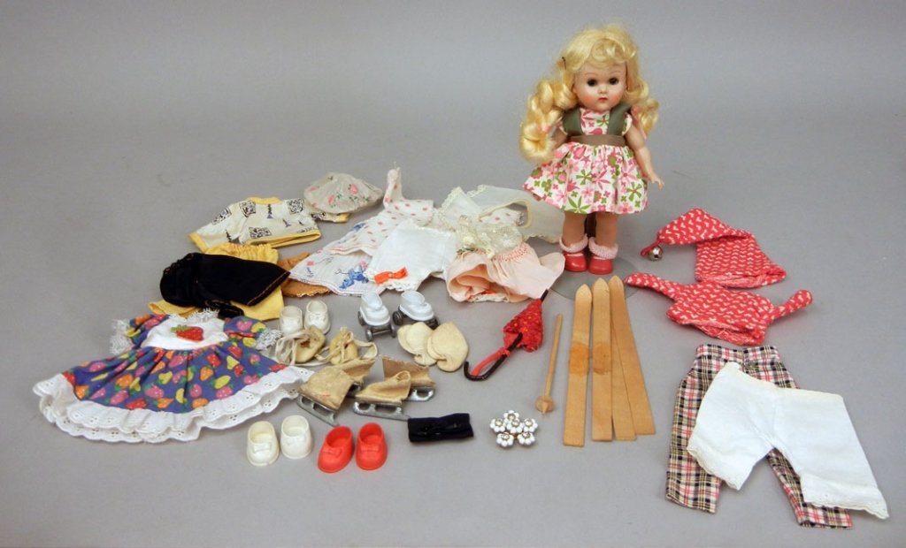 Vogue strung Ginny with additional clothes: Vogue strung Ginny with additional clothing and accessories, 1950s hard plastic walker, blue sleep eyes, wearing original tagged outfit, socks and shoes, marked on back, 7 1/2" high, with additional o