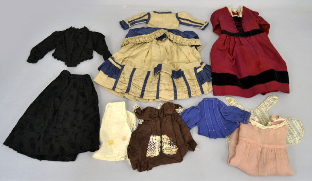 Antique and Vintage doll clothes: Antique and Vintage doll clothes, nine pieces, some with hand stitching, French Fashion, black two piece set, two dresses, apron, and three smaller dresses