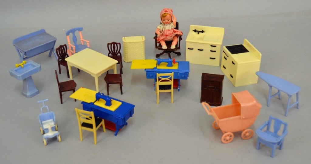 1950's Renwal doll house furniture: 1950's Renwal doll house furniture, including two sewing machines, ironing board, table, chairs, stove, sinks, laundry baskets, floor radio, baby carriage, push car, rocker, office chair, and doll