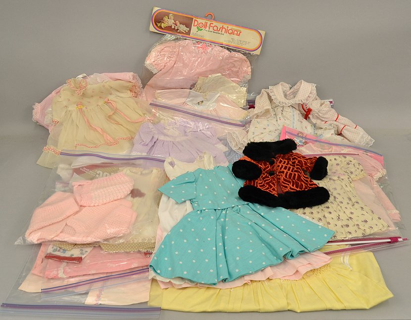 Grouping of doll clothing: Grouping of doll clothing, assorted sizes, some tagged, dresses, coats, sweaters, and more