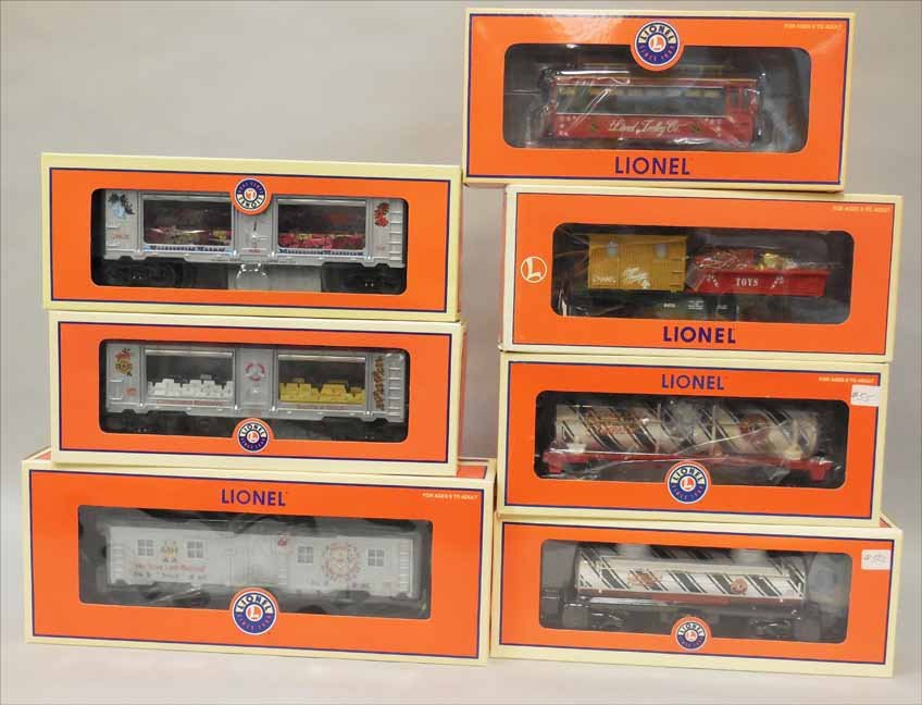 Seven Lionel train cars: Seven Lionel train cars, includes Elf Transport Work car 6-29608, Christmas Trolley 6-28418, Candy Cane Single Dome Tank Car 6-36108, Pointsettia Mint Car 6-29628, Silver and Gold Christmas Car 6-2969