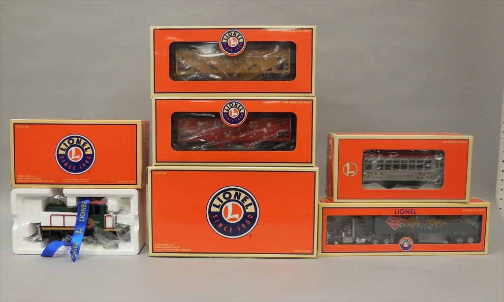 Four Lionel Christmas pieces: Four Lionel Christmas pieces, includes Christmas Tractor and Trailer 6-14260, 2003 Christmas Trolley 6-18481, Christmas Snowplow Motorized Unit 6-28427, and Naughty & Nice Hopper 2 Pack 6-16467, all i