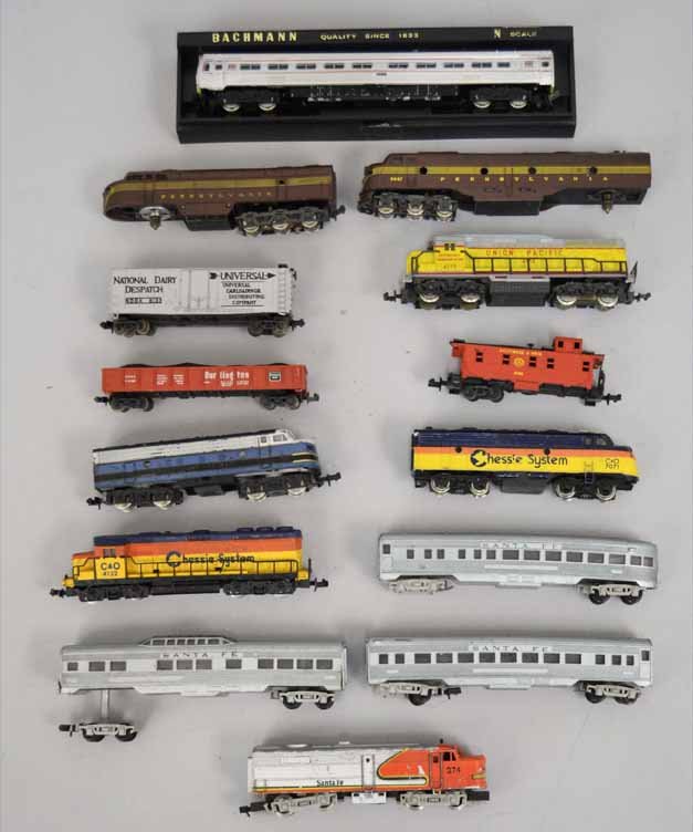 Grouping of N scale trains,: Grouping of N scale trains, includes Rapido Western Germany Sante Fe passenger train set, Bachmann engine in case, two Atlas Pennsylvania engines and a box car, Lima Union Pacific engine and a gondola