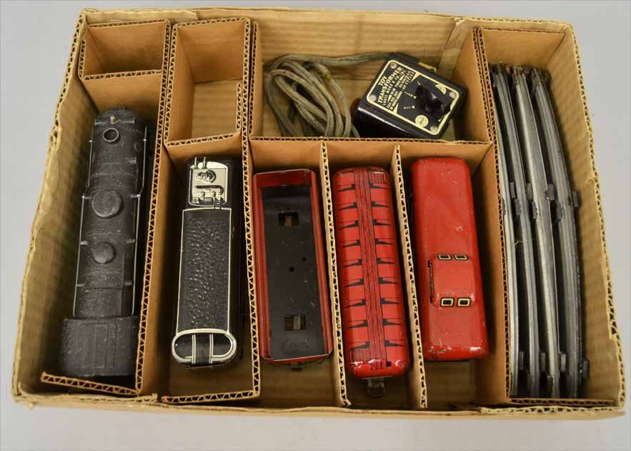 Marx tin litho train set, in set bottom box,: Marx tin litho train set, in set bottom box, includes Locomotive and tender No. 551, No. 552 Rock Island gondola, No. 555 Box car, and No. 556 caboose, eight curved track, and a transformer