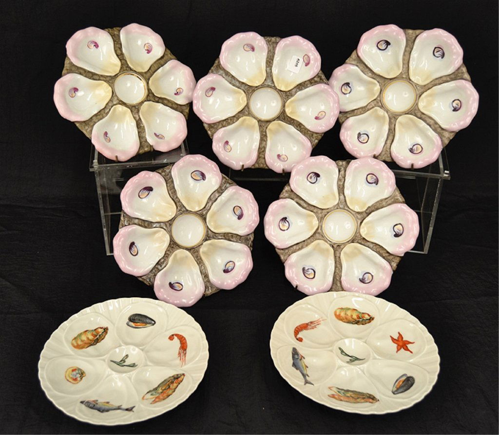 Seven oyster plates: Seven oyster plates, one set of five is pink and white, with six wells, unknown maker's mark on back, 9 1/2" diameter, and a pair by Pillivuyt France 682, 8 7/8" diameter, marked on back