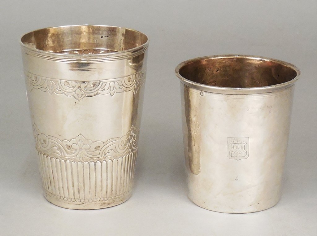 Two silver beakers: Two silver beakers, Cesar Tonnelier with engraved castle and shield cartouche, late 19th C., 3" x 2 3/4", and silver beaker with engraved and fluted decoration, unknown maker's mark, 4" x 3", 4.285 oz