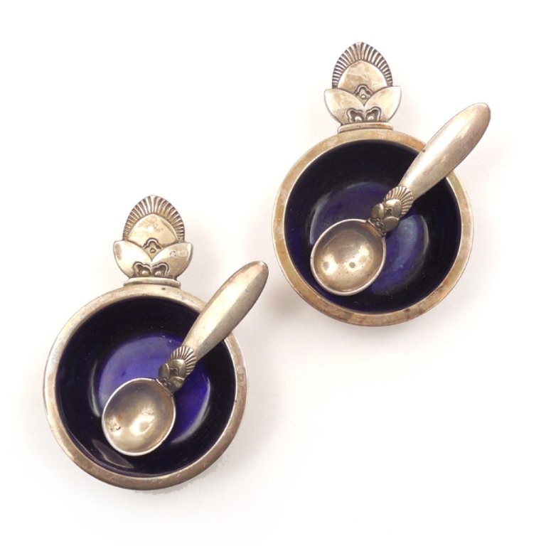 Pair of Georg Jensen "Cactus" salts: Pair of Georg Jensen "Cactus" salts with matching spoons, sterling silver with blue enamel bowl interior, marked on bottom "Georg Jensen & Wendell ALS, designers mark Dessin (Gundorph Albertus) 925, S