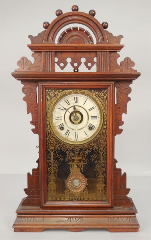 Seth Thomas walnut cased kitchen shelf clock: Seth Thomas walnut cased kitchen shelf clock, ball-top "Eclipse" shelf clock, eight day, painted dial with Roman numerals, reverse gilt stencil on glass, with "Eclipse" pendulum, 24 1/2" high x 14" x 