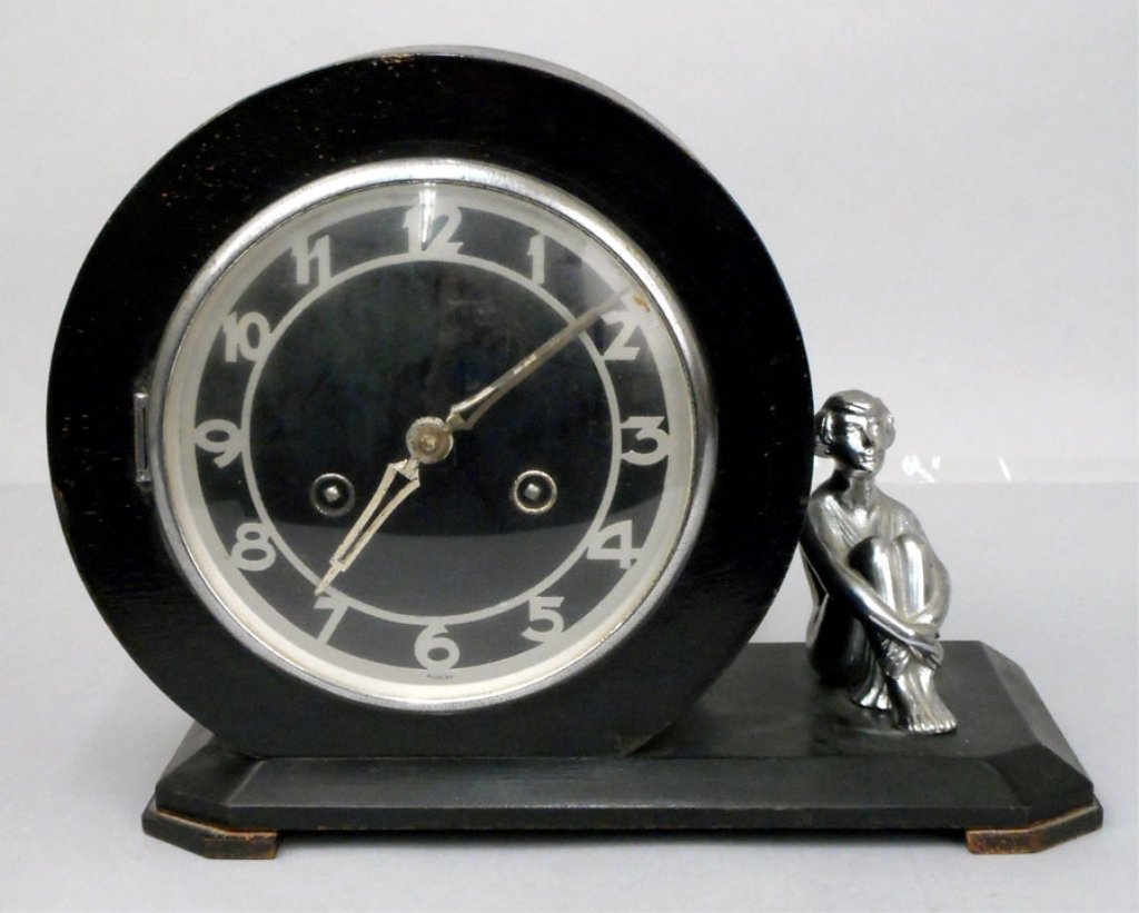 Franz Hermle & Sohn Art Deco clock: Franz Hermle & Sohn Art Deco clock, attached spelter female clock figure, FHS stamped on works, with a key and pendulum, 9" x 11 1/2" x 5 1/2"