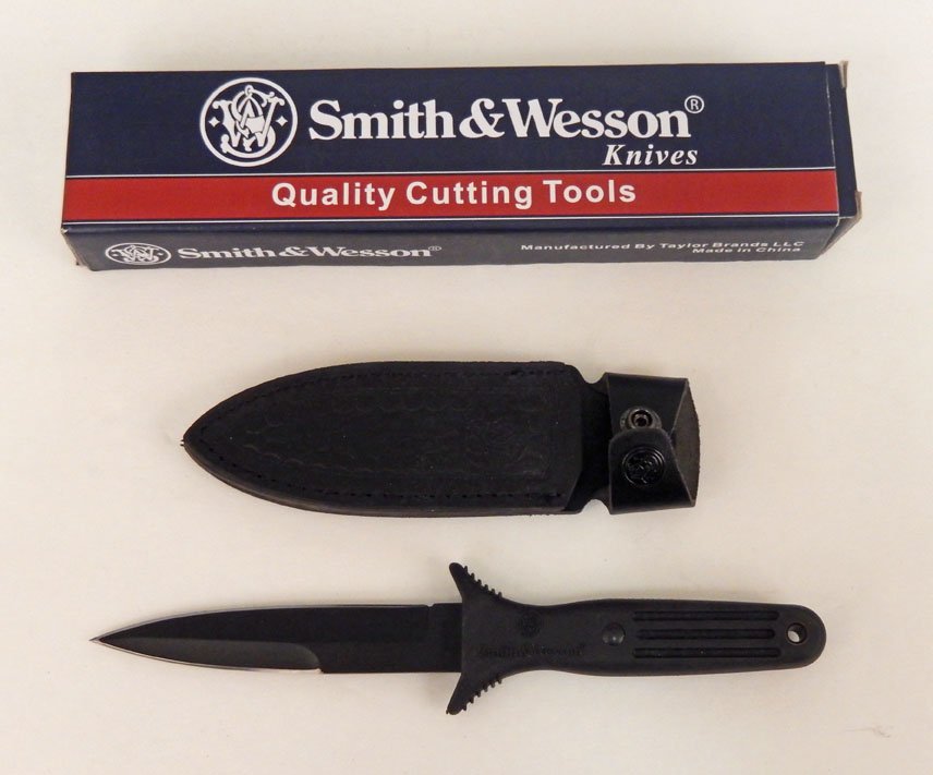 Smith & Wesson knife in leather scabbard with original: Smith & Wesson knife in leather scabbard with original box, SW820B, marked on blade, handle, and scabbard, blade length 5", overall length 10 1/4", box measures 10 1/2" x 2 1/4" x 1 1/2"