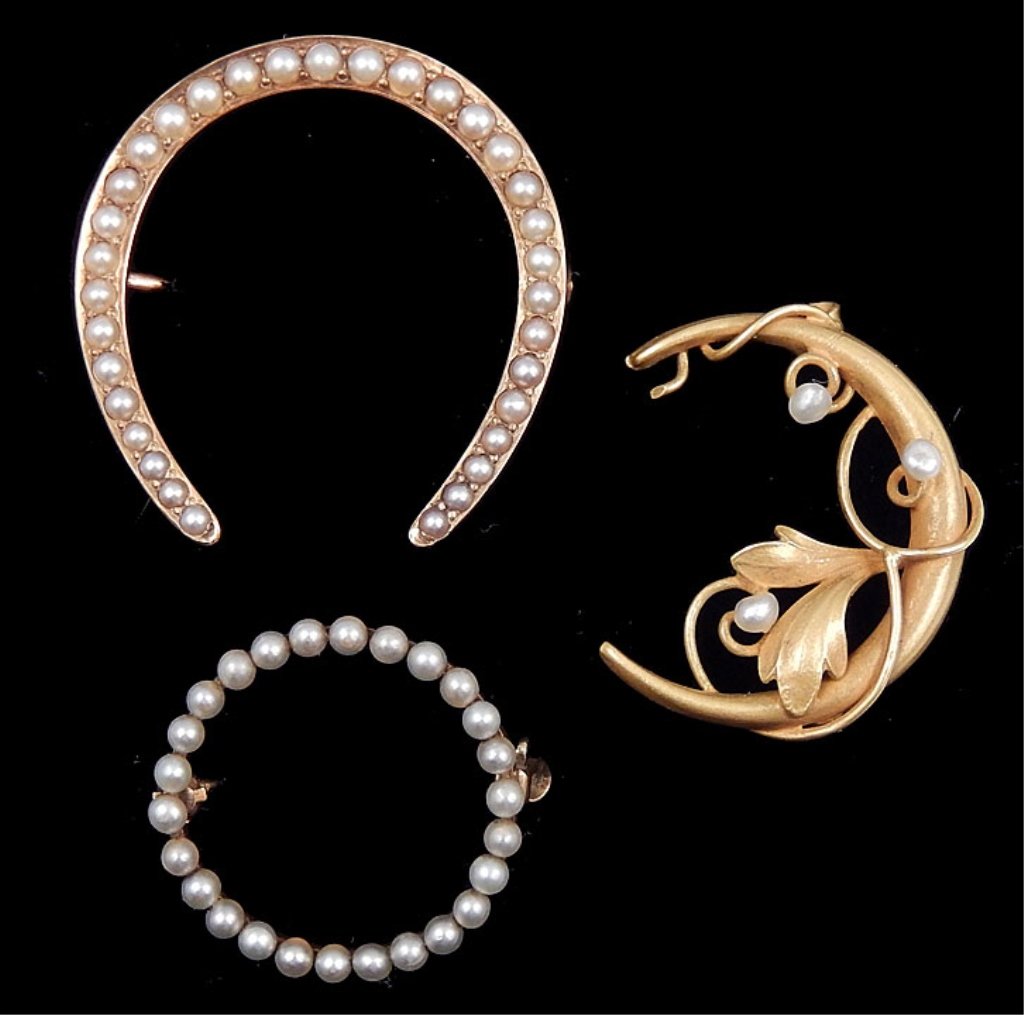 Three gold & pearl pins: Three Edwardian gold and seed pearl pins including one 10k gold crescent pin, 1" long, unmarked, one 14k gold horse shoe pin, 1 1/8" long, stamped 14k D.M., and one circle pin, 3/4" in diameter, stamp