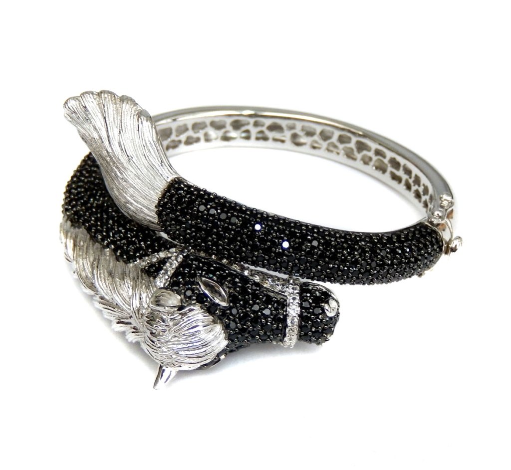 Sterling silver figural horse bracelet, black spinel: Black spinel, cz and sterling silver figural horse bracelet with crossover design, measures 2 5/8" across with a 7" inside circumference, hinged with dual safety catch, stamped 925, weighs 57 grams, c