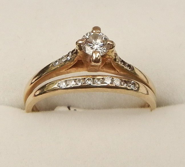 14k gold and diamond wedding ring set: 14k gold and diamond wedding ring set, band and solitaire are soldered together, one round diamond in center measuring approximately 0.25 carats, three 0.01 cts diamonds on either side, band is set wi