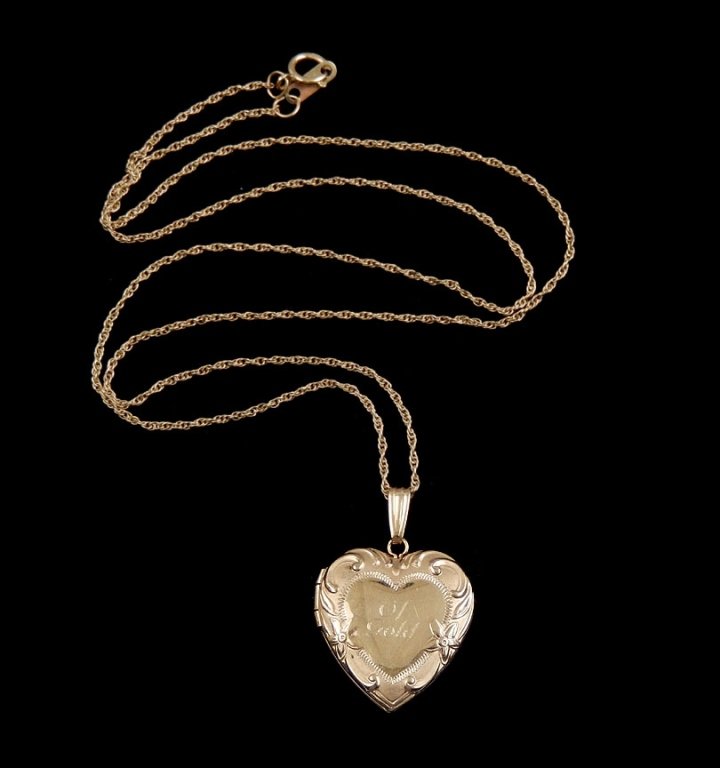 14k gold heart locket and chain: 14k gold heart locket and chain, locket with scroll and flower design, engraved on front "Of Gold" measures approximately 20mm by 20mm, on an 18" 14k chain, total weight 4.1 grams/2.6 dwt, contemporar