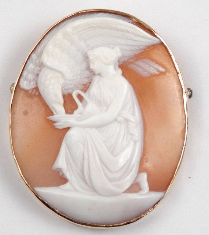 9ct carved shell cameo brooch: A late 19th or early 20th C large carved shell cameo brooch, depicting Hebe feeding Zeus in the guise of an eagle, set in 9ct gold mount, measures approximately 2" by 1 1/2", total weight 8.8 grams/5.