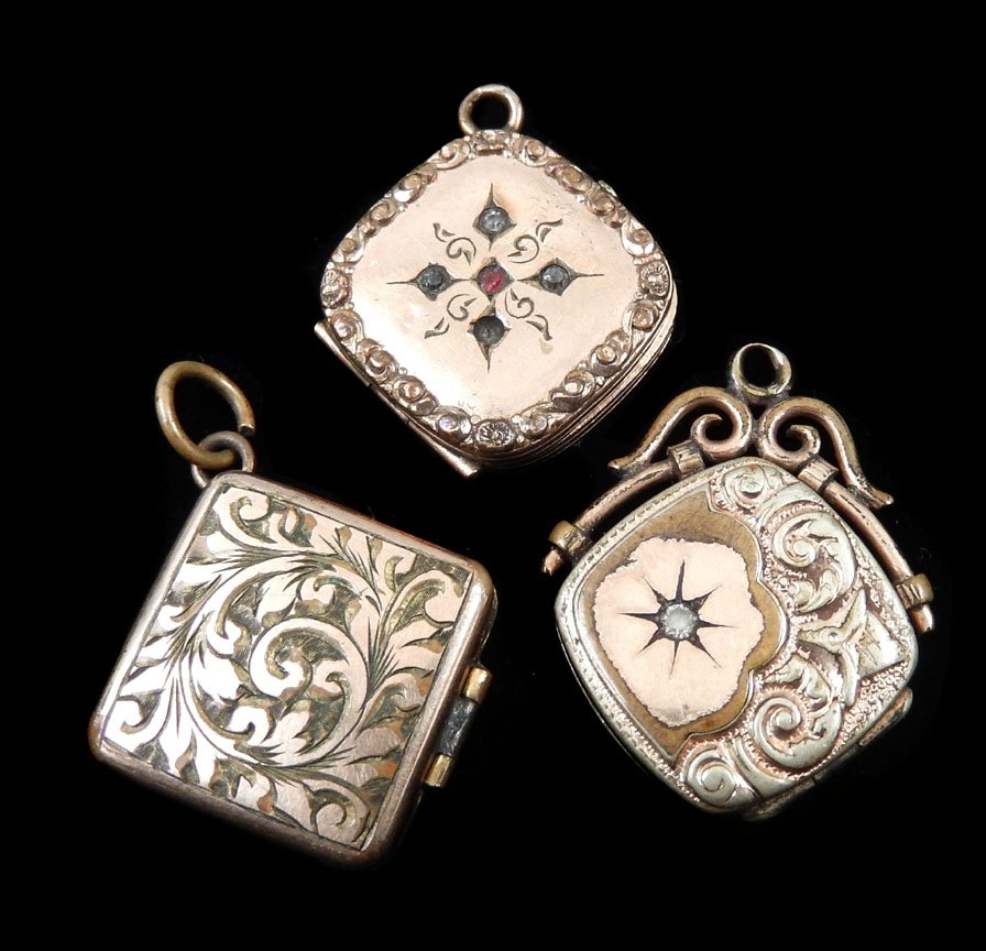 Three Victorian locket watch fobs: Grouping of three Victorian locket watch fobs, gold filled, unmarked, with floral repousse and engraving, each measure approximately 18mm x 18 mm