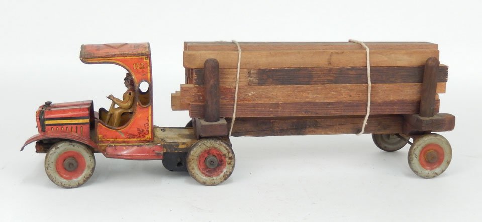 Timber King No. 112 tin litho truck by Strauss, wind up: Timber King No. 112 tin litho and wooden truck by The Ferdinand Strauss Corp. New York, U.S.A., wind up in working condition, with driver and sixteen lumber blocks, 20" long, Collection of John Dieter