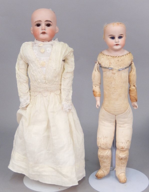 Two antique bisque shoulder head dolls: Two antique bisque shoulder head dolls, both with kid leather bodies, one marked "1896, COD 0 1/2, DEP, Made in Germany", brown glass sleep eyes, painted lashes, eyebrows, open mouth with upper teeth,