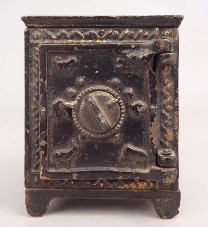 Cast iron animal safe bank: Cast iron animal safe bank, puzzle safe, gilt decoration, animals on front, marked on bottom "75, Pat. Feby. 15. 81, Pat. Mar. 1. 81", measures 3 1/8" x 2 1/2" x 2 1/2" Please be aware of shipping cos