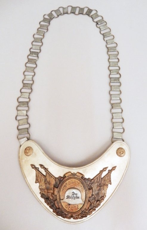 German Der Stahlhelm gorget with chain: German Der Stahlhelm gorget with chain, "Ortsgruppe Glatz" on front around helmet, marked on hook on back "RZM M34/2", measures 4 3/4" x 6 1/2"