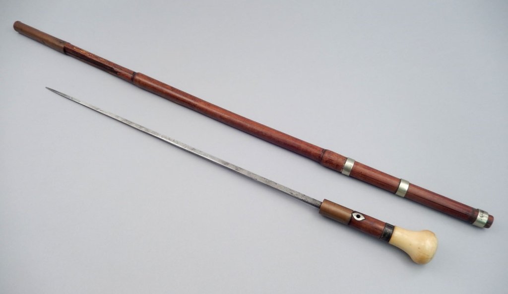 Antique cane with concealed dagger: Antique cane with concealed dagger, bone handle, copper fittings at top and bottom, blade 16 5/8", overall 33 3/8"
