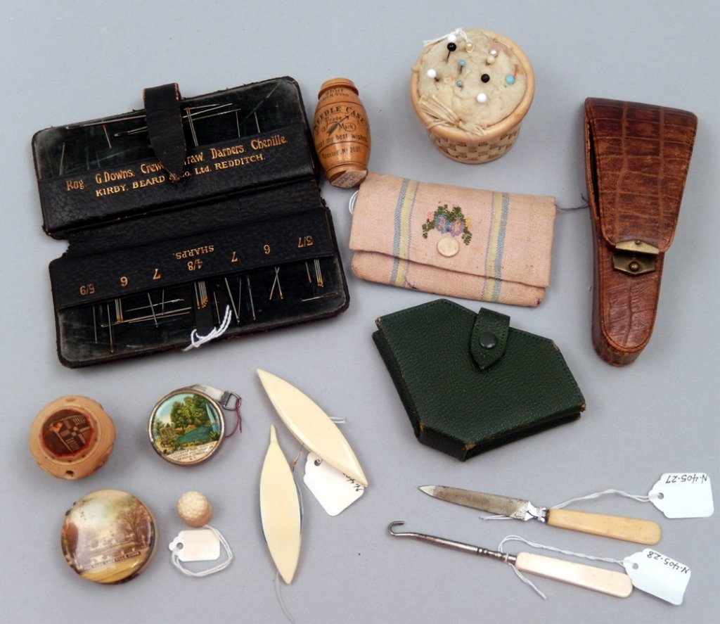 Collection of sewing items: Collection of sewing items, includes woven celluloid pin cushion basket, 2", carved pin cushion, 1 3/4", two celluloid tatting bobbins, 3", thimble, lace hook, 4 3/4", bone nail filer, 4 3/4", tape me