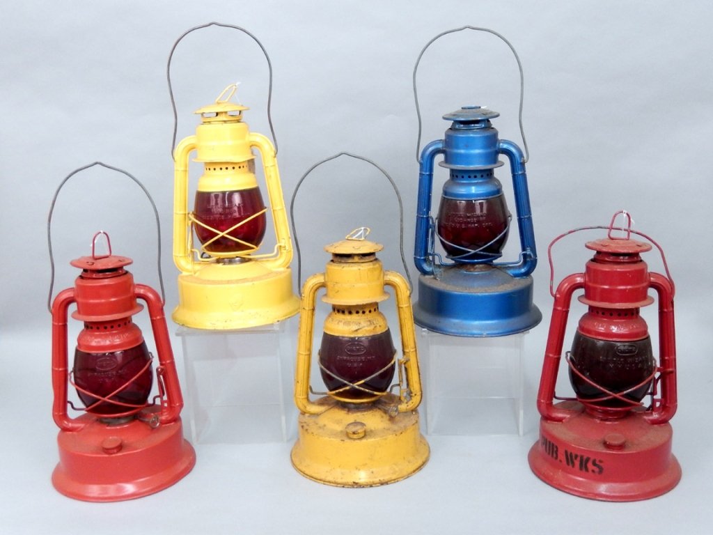 Five Dietz No. 100 Special lanterns: Five Dietz No. 100 Special lanterns, three are marked "City of Portland", painted red, yellow, and one blue, the red one is sprayed on base "Dept. of Pub. Works", the yellow one is sprayed on base "ST
