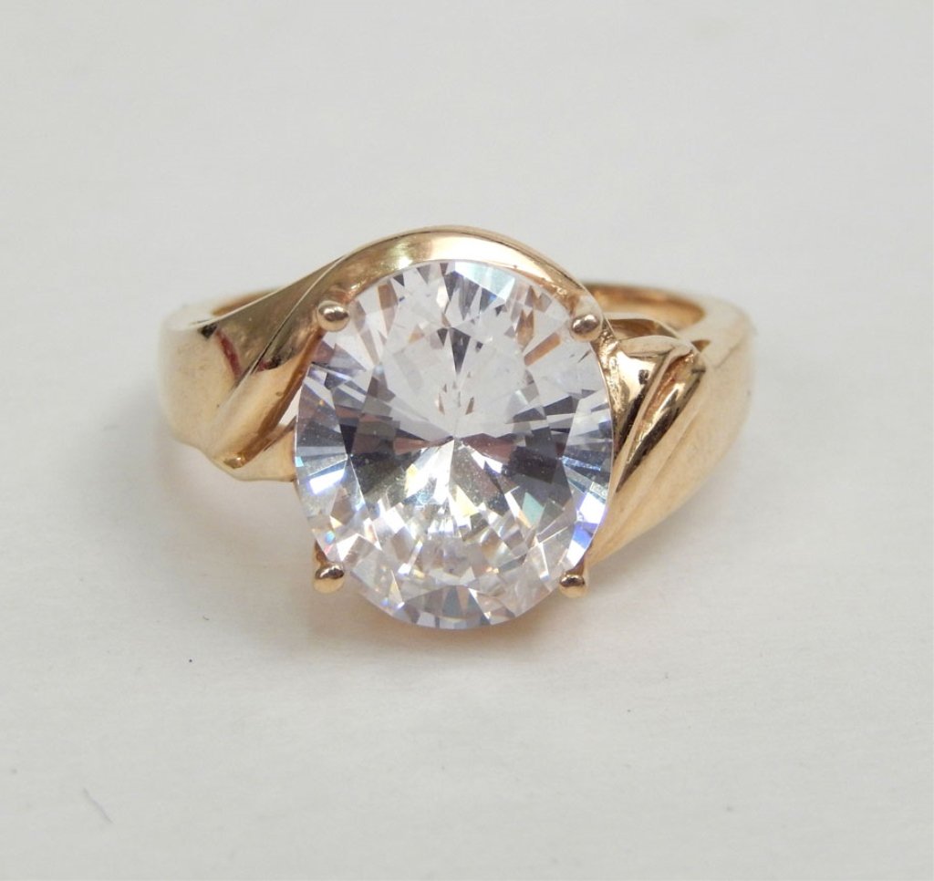14k gold and cubic zirconia solitaire ring: 14k gold and cubic zirconia ring with raised mount, stone measures approximately 14mm x 12mm, size 7, stamped 14k DO CZ, weighs 6.9 gr/4.4 dwt, late 20th C