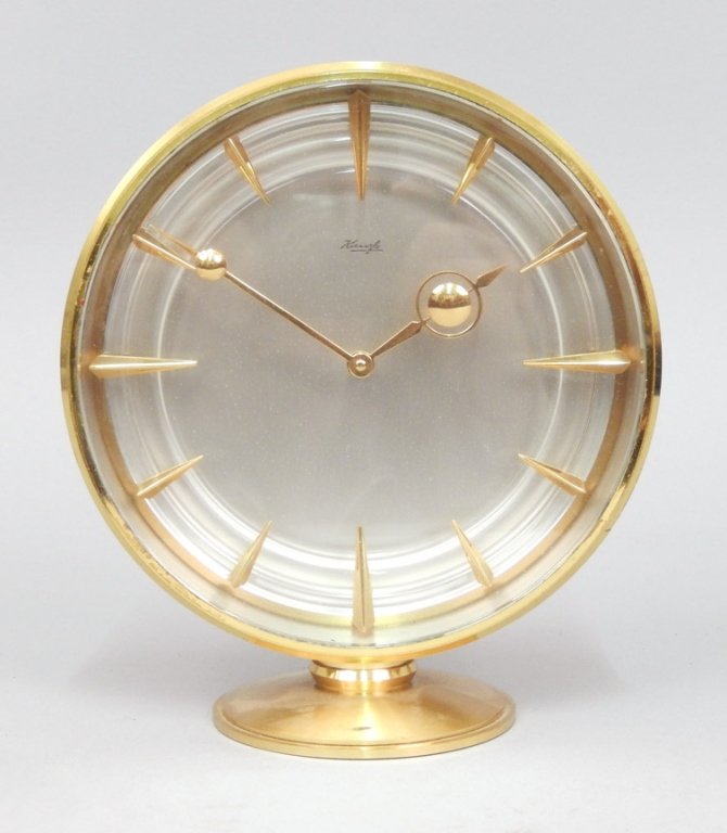 German Kienzle 8 day brass desk clock: German Kienzle8 day brass desk clock with silvered dial, gilded hands and markers, measures approximately 6 1/2" tall x 6" across,