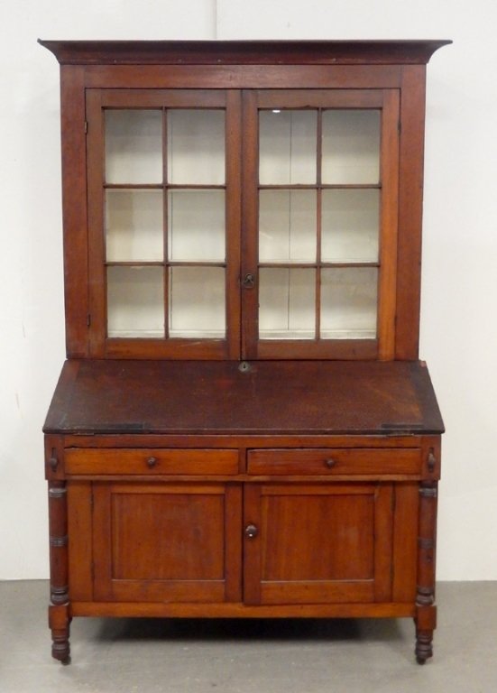 Poplar transitional slant lid desk with bookcase top: Poplar transitional slant lid desk with bookcase top, two piece, ogee cornice over double glass doors, each with six original glass panes, painted interior, on slant lid bottom section having interior