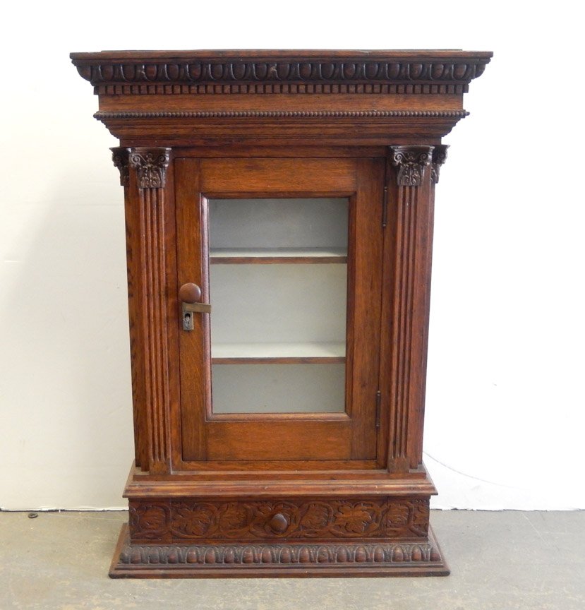 Oak glass door cabinet: Oak glass door cabinet, dentil and bead molding on cornice, fluted columns flank door, one drawer below, molded base, painted interior, 35 1/2" x 25 1/2" x 8"