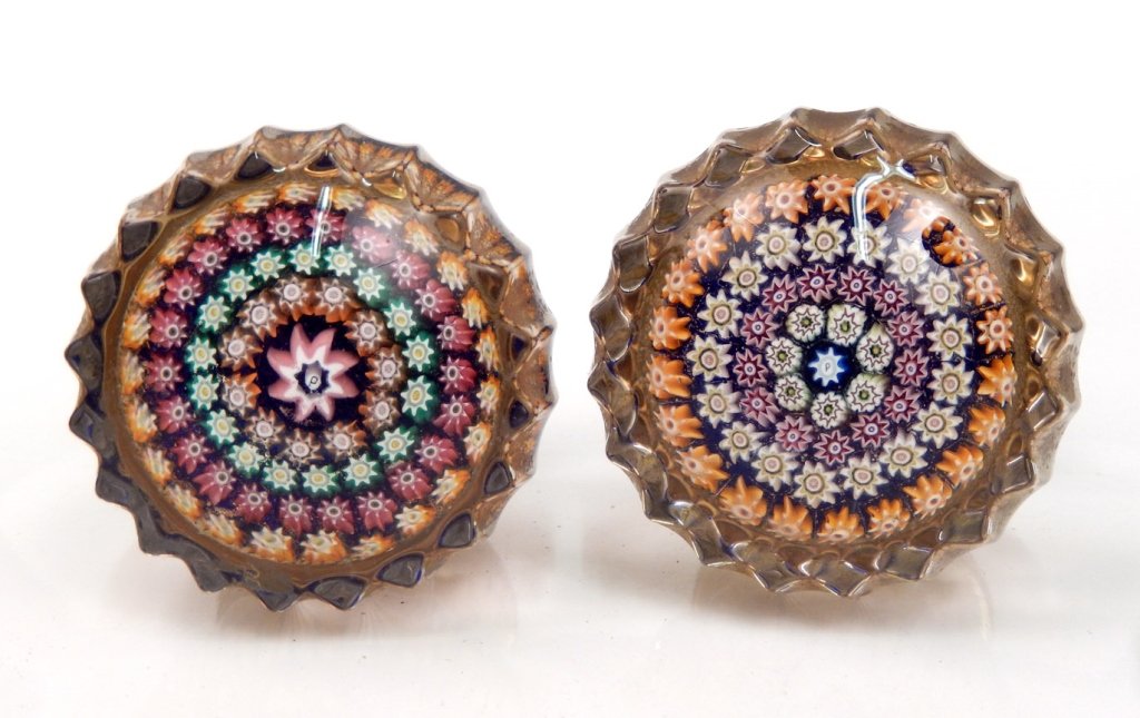 Two Perthshire millefiori door knobs: Two Perthshire millefiori art glass door knobs, centric millefiori design, center signature P cane surrounded by four rings of canes, one knobs ring colors are white, red, white and orange, other knob