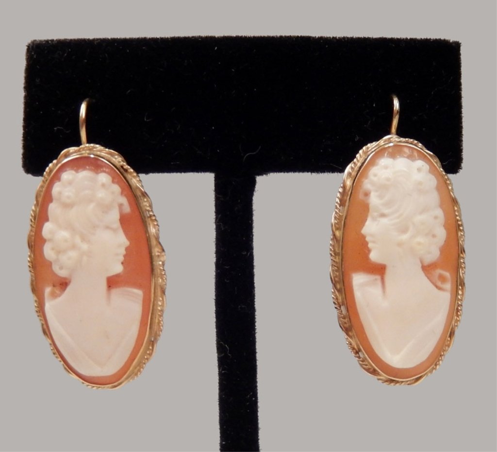 14k gold and cameo earrings: 14k gold and carved shell cameo earrings with locking French wires, each measures approximately 1" x 1/2", stamped 14k, weighs 4.8 gr/3.0 dwt complete, mid to late 20th.