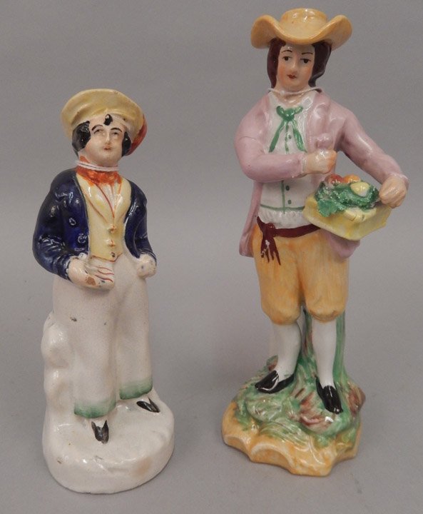 Two Staffordshire figurines: Two Staffordshire figurines, includes man holding basket of fruit, marked on bottom Old Staffordshire ware England, numbered 224, 6 3/4" high, and a sailor with pad in hand, 5 7/8" high, unmarked, mid