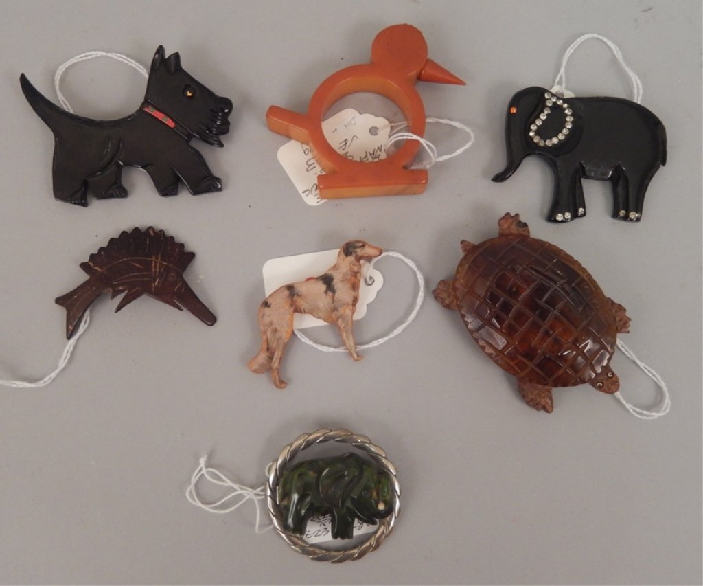 Grouping of bakelite animal pins and napkin ring: Grouping of bakelite animal pins and napkin ring, seven pieces, includes French Scottie dog pin, 2 1/4" x 3 1/4", 1930's wolf hound diecut bakelite pin, initialed on back, 1 3/4" x 2 3/8", king fisher