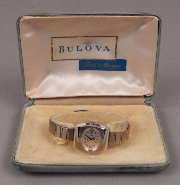 Bulova Accutron ladies wrist watch in original case: Bulova Accutron ladies wrist watch in original case, face marked Bulova Accutron Swiss, displays day of the week and date, back marked Bulova, gold electroplate steel, H 19089, stainless steel back, 7