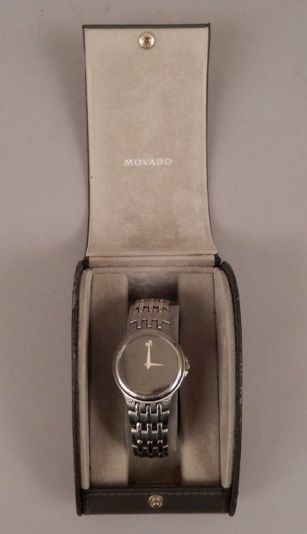 Movado men's wrist watch in case: Movado men's wrist watch in case, black dial, silver tone dot and hands, stainless steel band and case, dial marked Movado Swiss Made, back of case marked Movado, Stainless Steel Water Resistant Sapph