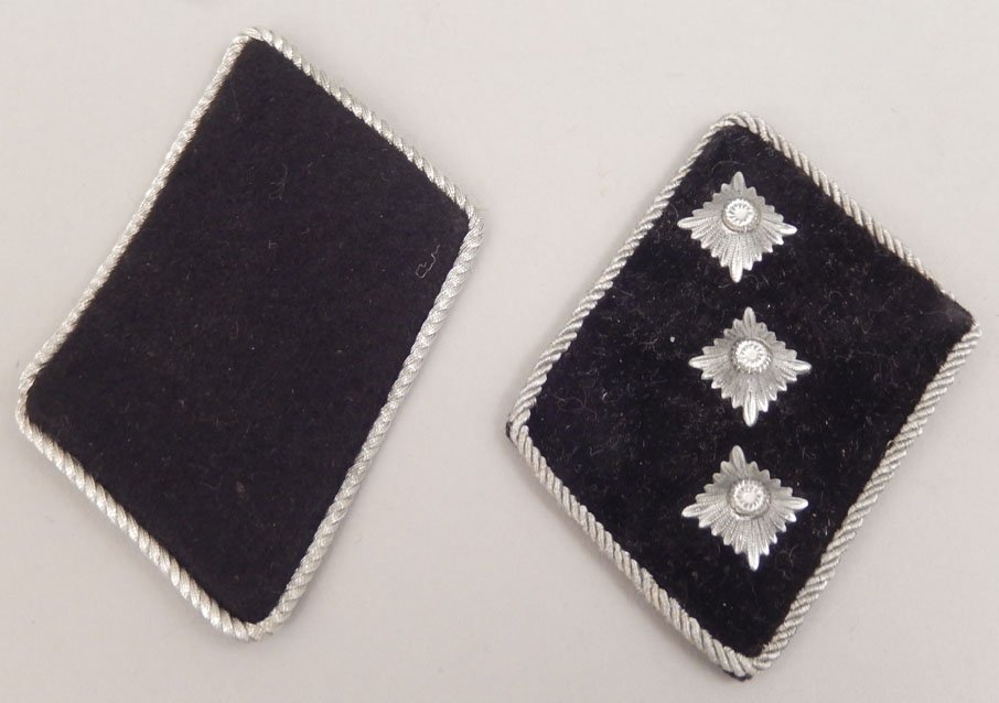 German SS collar tabs: German SS collar tabs, one with three rosette collar tab pins, other tab has label on reverse RZM Hersteller A4 375, Reichszeugmeisterei No. 5376