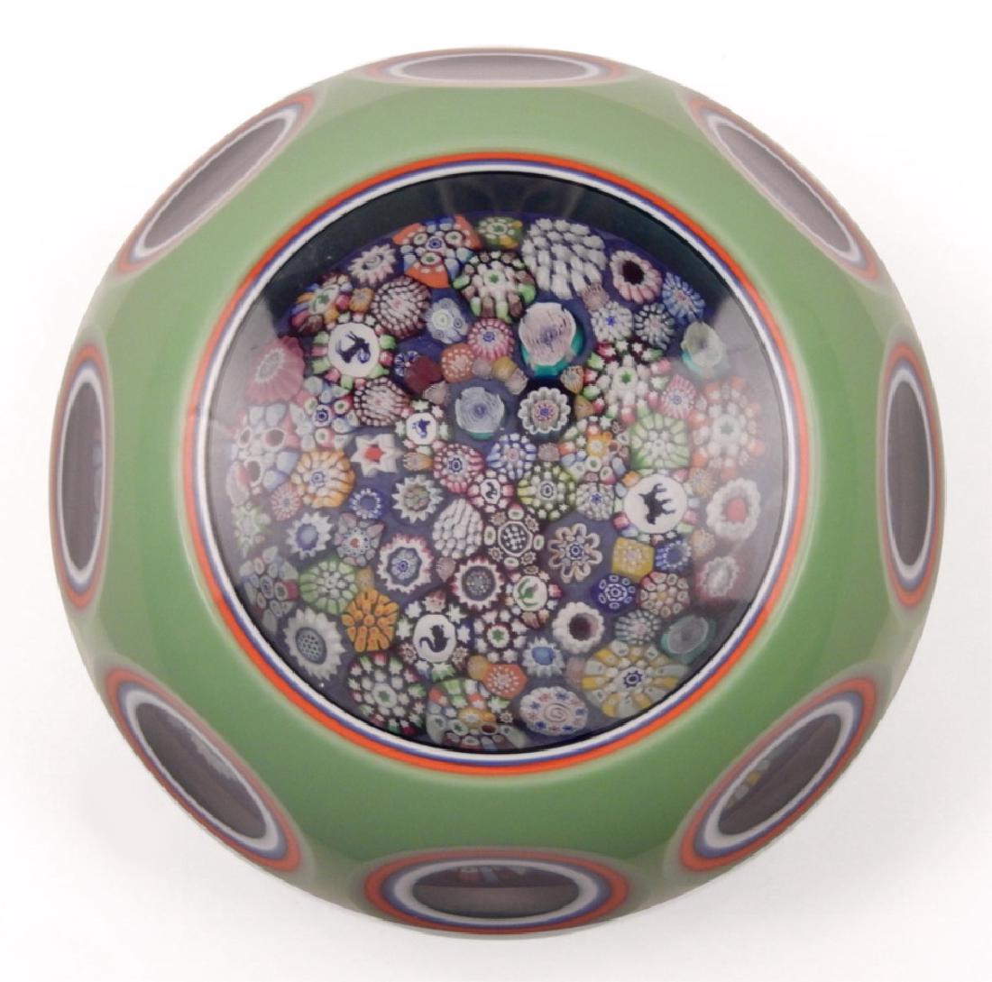 Magnum John Deacons art glass paperweight: Magnum John Deacons art glass paperweight, quintuple overlay spring green/ orange/ sky blue/ white/ and navy, enclosing a large closely packed millefiori paperweight, with colorful complex canes, scat