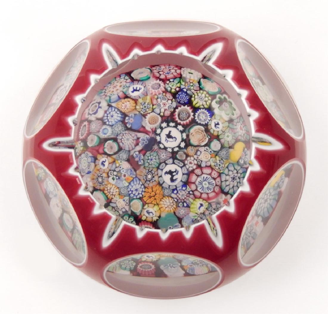 John Deacons art glass paperweight: John Deacons art glass paperweight, double overlay red and white, close packed millefiori with sharks tooth cutting, many complex canes pulled into a cushion within a clear dome, canes include a bird,