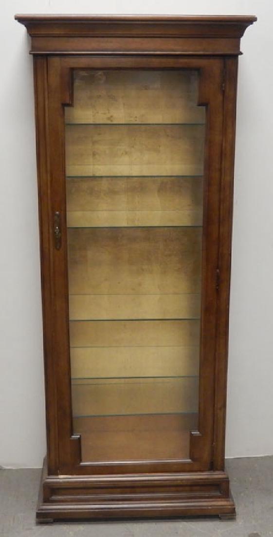 Petite cherry lighted curio: Petite cherry lighted curio, overhanging molded cornice over single glass door, molded base, American of Chicago label on back, 62 1/2" x 26 1/4" x 13 1/2"